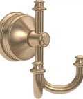 Close-up of a brass wall-mounted double towel hook, part of a bath hardware set for modern bathrooms.