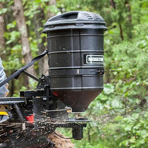ATV Spreader With Manual Feed Gate For Seed Or Fertilizer, 100 Pound Hopper, Heavy Duty 12 Volt Motor, mounted on ATV in forest