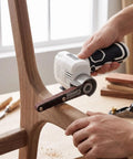 Using NoSweat 12V Cordless Detail Belt Sander on wood for precise sanding in tight spaces, showcasing brushless motor design.