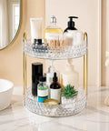 Two Tier Clear Rotating Makeup Organizer Stand Featuring Butter Smooth 360 Spin And Rock Solid Wobble Free Stability For Your Daily Skincare Routine With Reinforced Metal Base and clear cosmetic products displayed.