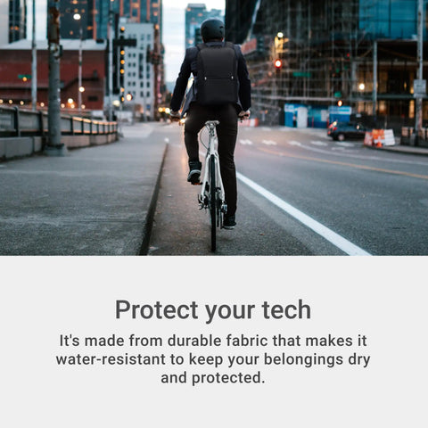Man biking in urban setting wearing a Sustainable Laptop Backpack Engineered For 16 Inch Devices, showcasing water-resistant features.