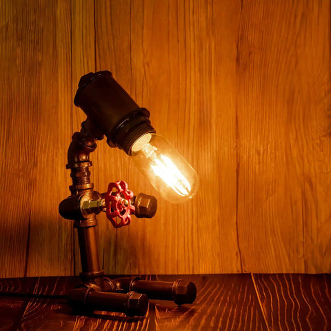 Old School Edison Style LED Filament Tubular Bulb in vintage fixture on wooden background, warm glow, E26 Dimmable, 2700K, 40W Equivalent