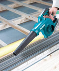 Person using Lightweight 18V LXT Cordless Blower With 219 MPH Air, 3-Speed Variable Power in workshop, tool only