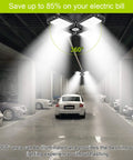 Deformable 120W LED Garage Light Four Panel Ceiling Fixture illuminating a garage with cars parked on each side.