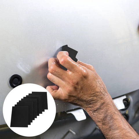 Person using Heavy Duty 9 Sheet Black Silicon Carbide Sandpaper Assortment With Nine Grits For Dry Wet Sanding on a surface.