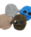Four colorful Unisex Peak Ski Beanies With Thick Fleece Lining, Cozy Knit Hat For Winter, in gray, blue, brown, and olive, laid out flat.
