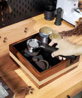 Professional Grade Wooden Espresso Knock Box And Sleek Tamping Station With Beefy Stand Base For Real Hustle Fits Standard 58mm Portafilters Home Barista Setup with coffee grounds on counter.