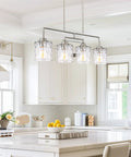 Monroe 28 Inch Modern Four Light Linear Kitchen Island Light With Hammered Glass Shades Brushed Nickel Finish in kitchen setting