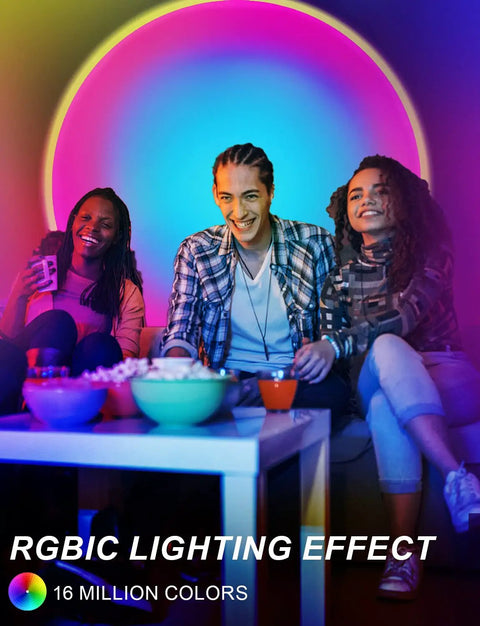 Sunset Projection Lamp With 64 Color Options, App Controlled Ambient Light With Ivy Leaves For Bedrooms And Parties, Indoor Vibe Setter, Projector Lamp For Cozy Movie Nights And Birthday Celebrations illuminating a room with people