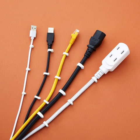 Round Cable Wire Clips Set For Wall Mounting And Cable Management, Hassle-Free And Tangle-Free Mounts, 5 cables mounted on orange surface