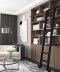 Black Sliding Ladder Hardware Kit With Ladder And Full 700cm Track installed in a modern library loft setting with wooden shelves.