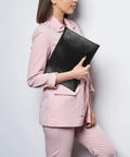 Woman holding heavy duty fireproof and waterproof document money bag with zipper pouch for emergency prep, 10 by 13.5 inch.