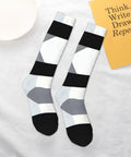 Black And White Piano Grid Thigh High Socks Unisex Breathable Moisture Wicking Crew Socks For Women Men laid flat, showcasing design and comfort.
