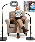 Man using 5X Real Glass Floor Magnifier With Light And Stand while reading, showing flexible stand and ULTRA-BRIGHT 56 LED Lamp.
