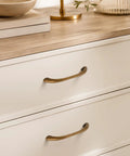 10 Pack Antique Brass Cabinet Pulls With Ergonomic Curved Grip For 5 Inch Kitchen Cabinets showcased on white drawers