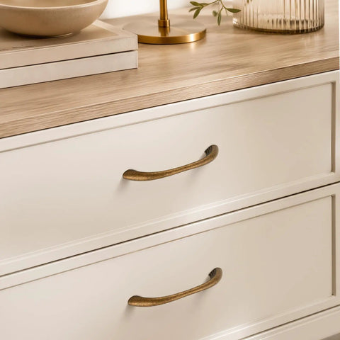 10 Pack Antique Brass Cabinet Pulls With Ergonomic Curved Grip For 5 Inch Kitchen Cabinets showcased on white drawers