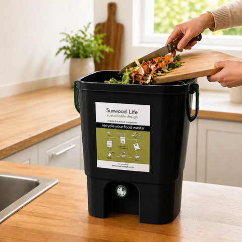 Indoor Bokashi Composting Starter Kit With 2.2 lb Premium Bokashi Bran in black, shown on a kitchen countertop with food scraps.