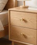 4 Pack Gold Solid Brass Round Drawer Knobs With Mounting Screws for Cabinets Dresser Kitchen and Bathroom Hardware installed on wooden drawer.