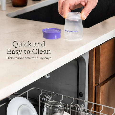 Soft Anti Colic Nipples For Everyday Bottle Feedings Paired With 5 Oz Breastmilk Storage Bottles In A Four Pack being held over a dishwasher.