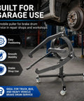 Beefy Three Jaw Brake Drum Puller With Adjustable Arms And Four Caster Legs For Cars And Trucks in garage setup