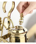 Top Shelf Siphon Coffee Maker Syphon Glass Brewer 4 Cup with a hand attaching the metal part, showcasing its ergonomic design.