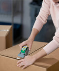 Person sealing box with EZ Start Packing Tape With One Handed Dispenser 1.88 Inch By 55.5 Yard Crystal Clear Tape Roll