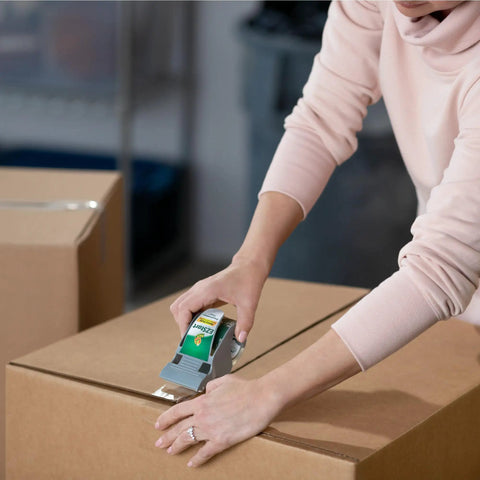 Person sealing box with EZ Start Packing Tape With One Handed Dispenser 1.88 Inch By 55.5 Yard Crystal Clear Tape Roll