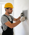 Person using Easy Peasy Drywall Repair Kit With Patches, Sandpaper And Scrapers For 2In To 8In Holes on a wall.