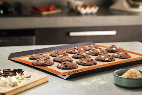 Nonstick Silicone Baking Mat For Cookies, Pro Grade Quality With Fiberglass Mesh For Even Heat shown with chocolate cookies