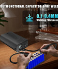 Portable Capacitor Spot Welder With Crisp LCD Display And 120 Pulse Controls for 18650 battery packing on a workbench.