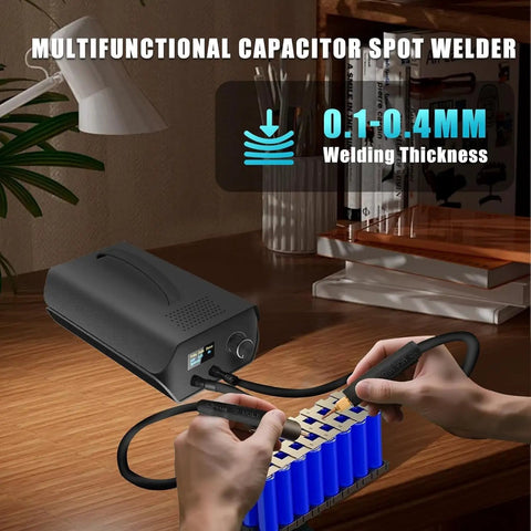 Portable Capacitor Spot Welder With Crisp LCD Display And 120 Pulse Controls for 18650 battery packing on a workbench.