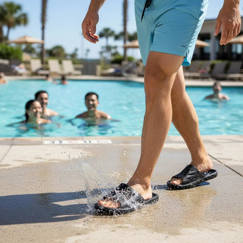 Person wearing Drainage Holes Shower Slippers With Quick Drying Sole For Men And Women Open Toe Bath Shoes Soft Cushioned Footbed Ultra Comfy For Home Gym Pool And Spa Black 44.45 by poolside.