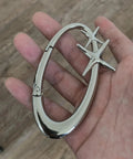 Hand holding a Star Shaped Carabiner Keychain With Belt Loop Clip Silver Cool Durable Stainless Steel Heavy Duty Snap Hook.