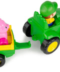 Animal Sounds Wagon Ride Musical Tractor Toy Set for Toddlers, farmer figure driving a green tractor with a pink pig in the wagon
