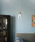 Top Shelf Champagne Bronze Mini Pendant Light With Clear Glass Shade For Kitchen Island And Chill Vibes Down Right Sleek Indoor Ceiling Fixture featuring adjustable drop chain and clear shade above a cozy sofa.