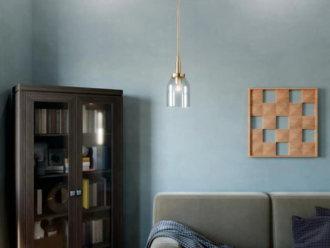 Top Shelf Champagne Bronze Mini Pendant Light With Clear Glass Shade For Kitchen Island And Chill Vibes Down Right Sleek Indoor Ceiling Fixture featuring adjustable drop chain and clear shade above a cozy sofa.
