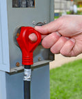 Hand plugging RV Power Cord 30 Amp 25 Foot with 90 Degree Detachable Plug Red into an outdoor power outlet