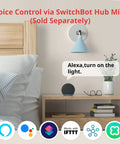 Nightstand with voice-controlled smart button pusher setup next to a bed, showcasing Bluetooth control and optional hub for voice commands.