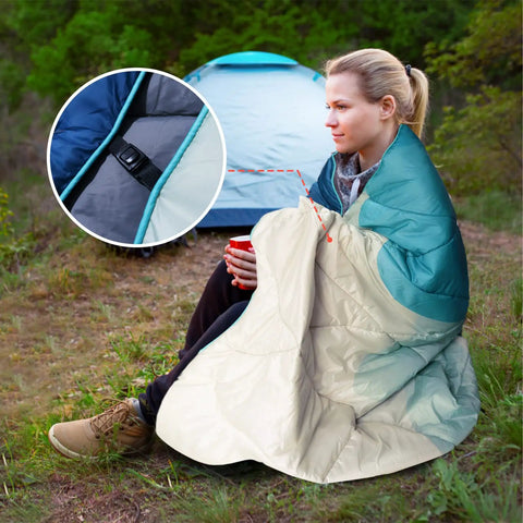 Woman wrapped in Outdoor Puffy Camping Blanket with Lightweight Down Alternative Fill near tent