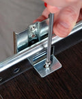 Installing Rock Solid 14 Inch Keyboard Drawer Slides With Smooth Ball Bearings on a desk using a screwdriver.