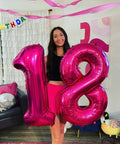 Hot Pink Number 8 Balloon 40 Inch Giant Foil Balloon For 8th Birthday Party Decor Epic Photo Backdrop Prop Large 8 Balloon For Party Supplies Bold Birthday Decor That Pops And Stays Put next to a number 1 balloon held by a woman indoors.