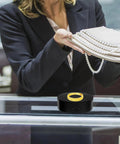Chic Electric Rotating Display Stand 13CM Silent 360 Turntable Pedestal showcasing a ring and pearls in a jewelry store.