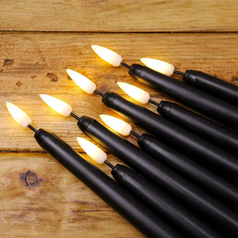 Pack Of 12 Flameless Taper Candles 11 Inch Flickering Warm White LED Candles Battery Powered Realistic Plastic Candles For Christmas Decor Easy On Off Switch Safe Cozy Glow For Tables And Mantels on a wooden surface
