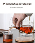 Person pouring from a glass vessel with V-shaped spout into a decorative cup, showcasing the Kickback Cold Brew Dripper Coffee Tower.