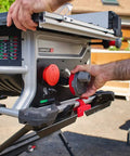 Heavy Duty Compact Table Saw With Patented Skin Contact Safety System and Precision Rack Pinion Fence operation controls in use.