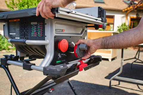 Heavy Duty Compact Table Saw With Patented Skin Contact Safety System and Precision Rack Pinion Fence operation controls in use.