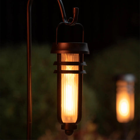 Close-up of Metal Solar Torch Lights With Adjustable Height From 24 To 50 Inches For Outdoor Yard Patio And Garden Pathway Waterproof Tiki Torches