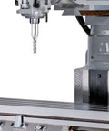 CNC milling machine spindle holding a 1/8-inch end mill over a metal worktable