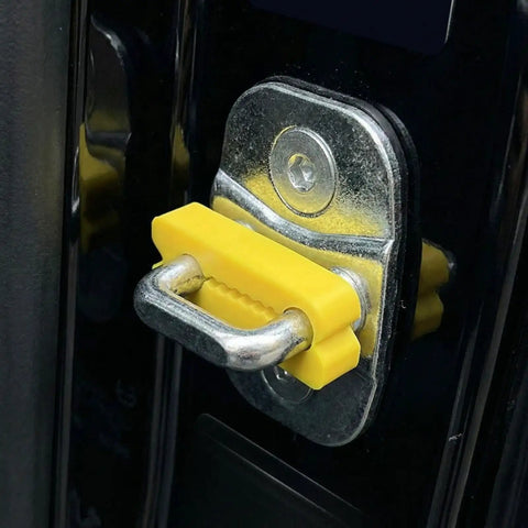 Close-up of a yellow door lock shock absorber pad on a car latch. Door Lock Shock Absorber Pads 4 Pack Red Rubber Noise Dampening Bumpers