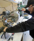 Person using 10 Million Dollar Stick For Safe Small Part Cutting With Wishbone Grip And Rubber Feet Injection Molded Standalone Holder